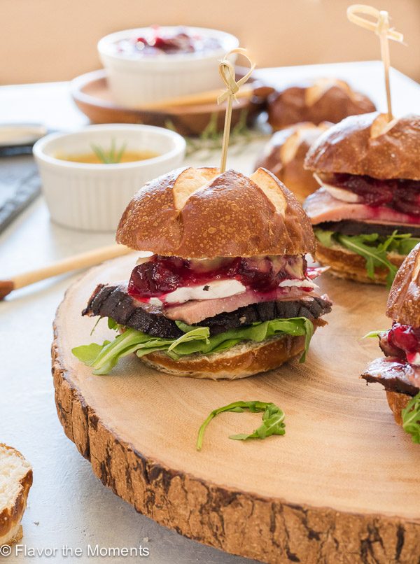 Ham, brie and cranberry slider with a toothpick through the top bun