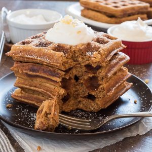 Stack of gingerbread waffles with a bite out