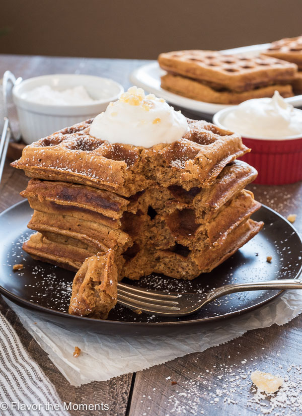 Stack of gingerbread waffles with a bite out