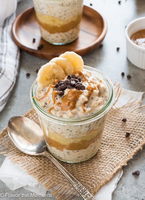 Peanut butter banana overnight oats in a jar with peanut butter and chocolate chips on top