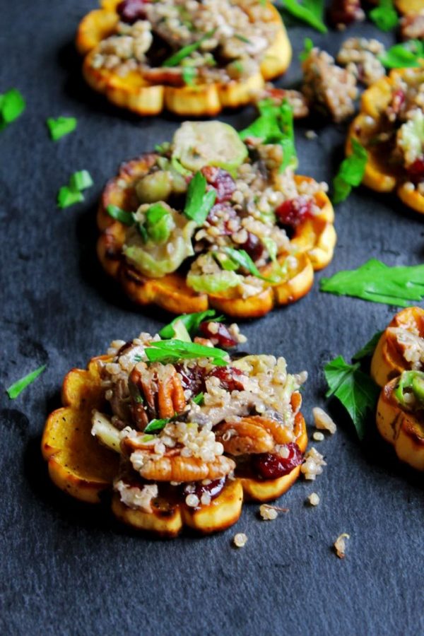 Quinoa stuffed roasted delicata squash rings on baking sheet