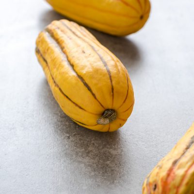 Produce of the Month Guide: Delicata Squash includes everything you want to know about delicata squash with a video tutorial on how to prep it and a recipe round up!