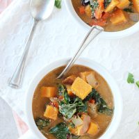 Sweet potato swiss chard soup in bowl with spoon