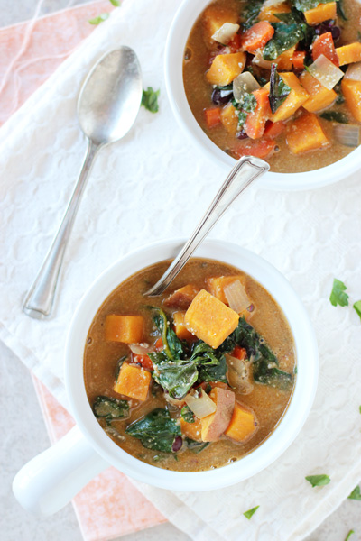Sweet potato swiss chard soup in bowl with spoon