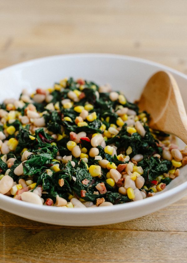 Swiss chard with pancetta, corn and beans in white bowl