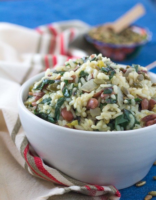 Chard and pinto bean risotto in white bowl