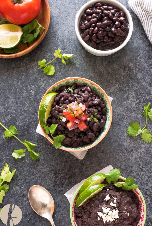Refried black beans in a bowl with pico de gallo on top