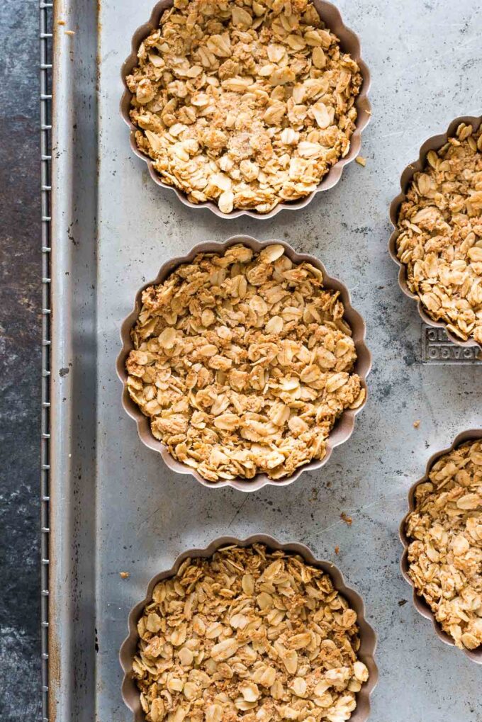 Granola tart shells baked in mini tart pans.