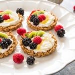 breakfast fruit tarts with granola crust, yogurt filling, and fresh fruit.