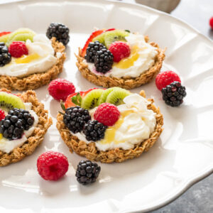 breakfast fruit tarts with granola crust, yogurt filling, and fresh fruit.