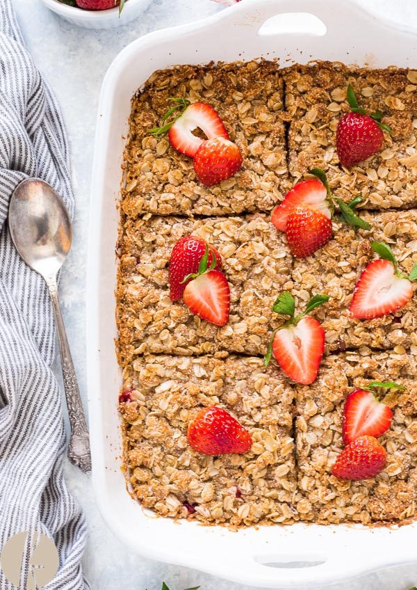 Strawberry rhubarb baked oatmeal crisp in baking dish cut into squares
