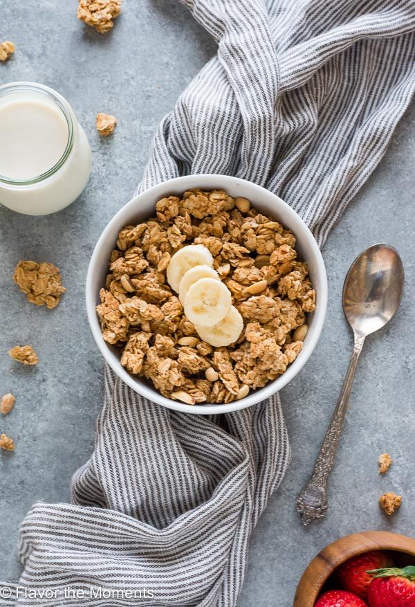 overhead shot of Peanut Butter Granola in a white bowl topped with bananas