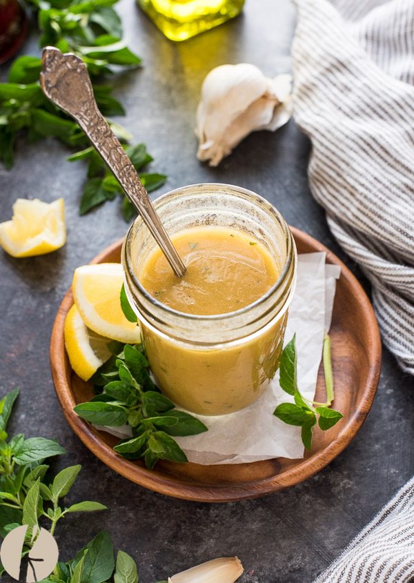 Greek salad dressing with spoon dipped in