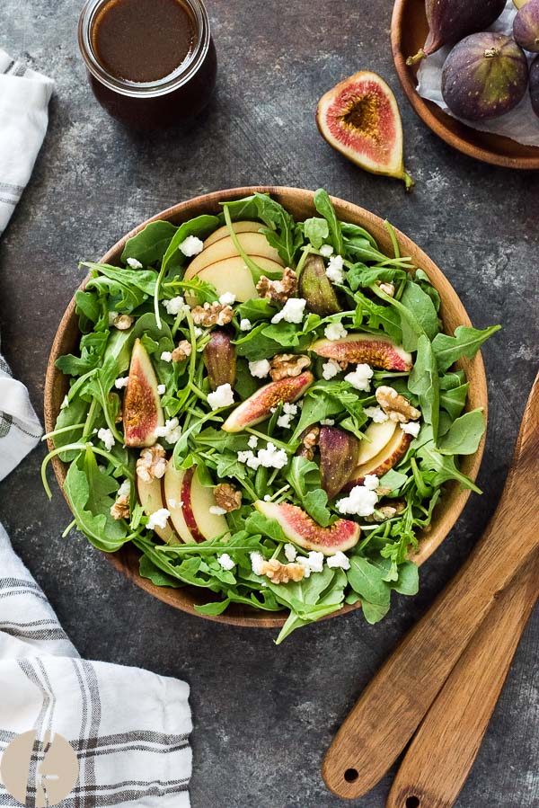 Apple fig arugula salad in a bowl with servers