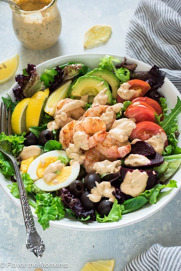 shrimp louie salad with dressing drizzled over