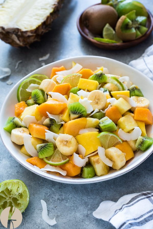 Close up of tropical fruit salad in a white bowl