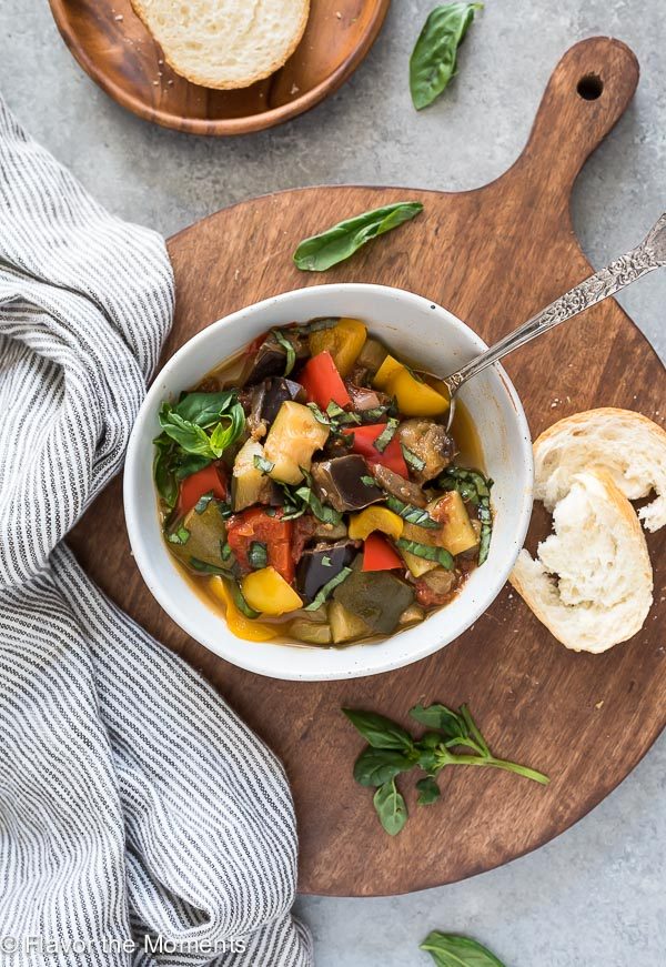 bowl of ratatouille with spoon inside and bread