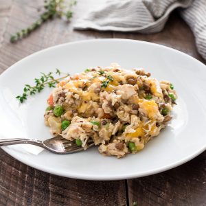Crockpot chicken and rice on a white plate with fork