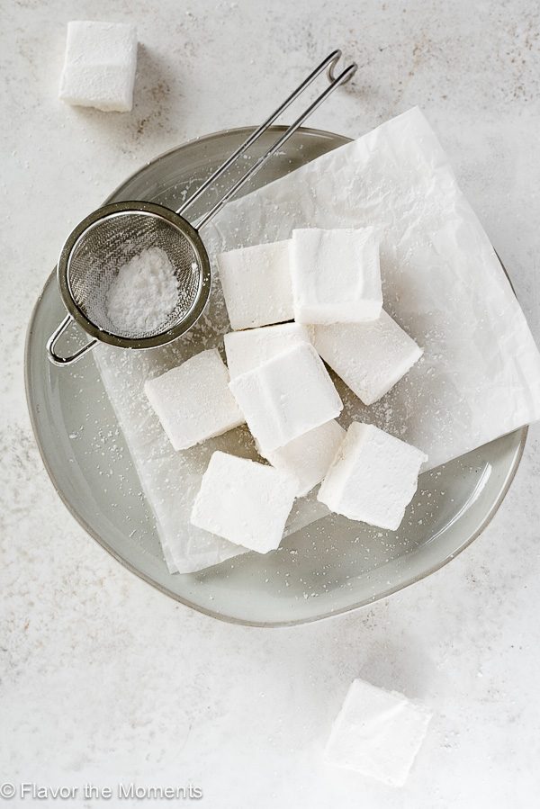 Homemade marshmallows on a plate with sieve