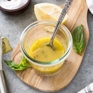 Jar of homemade Italian dressing with spoon