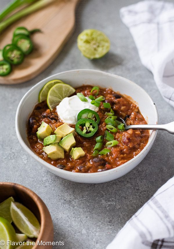 Lentil chili front view with spoon dipped into bowl