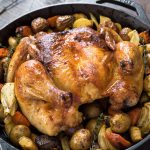 Spatchcock roast chicken in skillet with potatoes, fennel and carrots