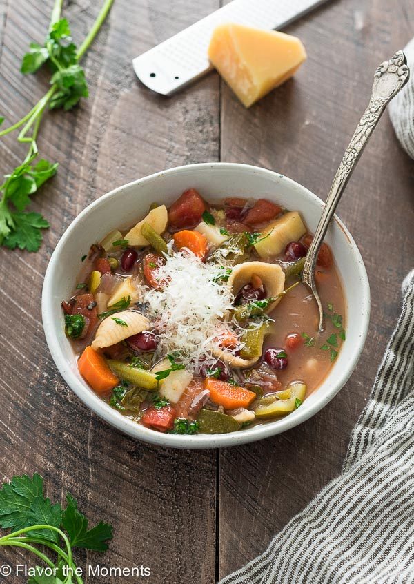 Bowl of Instant pot vegetarian minestrone soup with spoon and parmesan