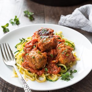 Paleo turkey meatballs on white plate with zoodles