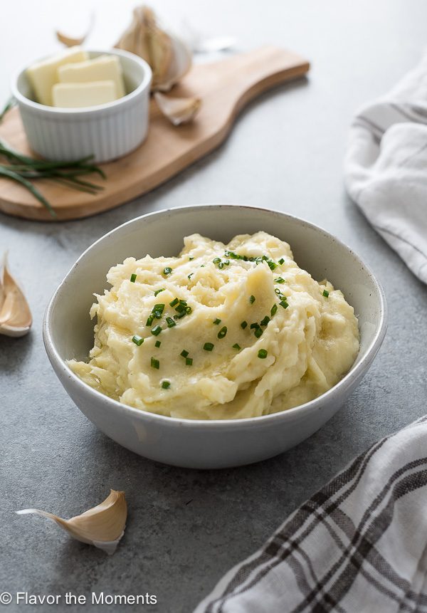 Instant pot mashed potatoes in a bowl with chives and butter on top