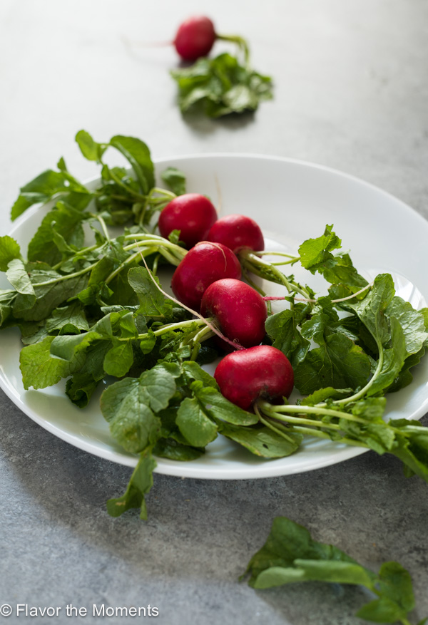 Radishes on a round white plate