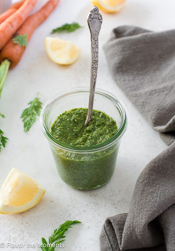 pesto sauce in jar with spoon in center