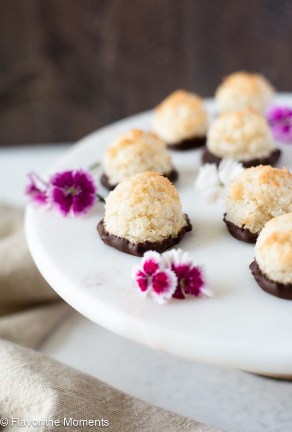 chocolate dipped coconut macaroons front angled view on pedestal