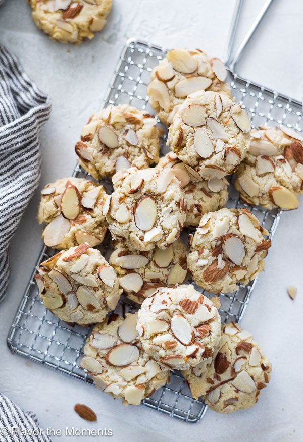 Greek almond cookies piled on a wire rack