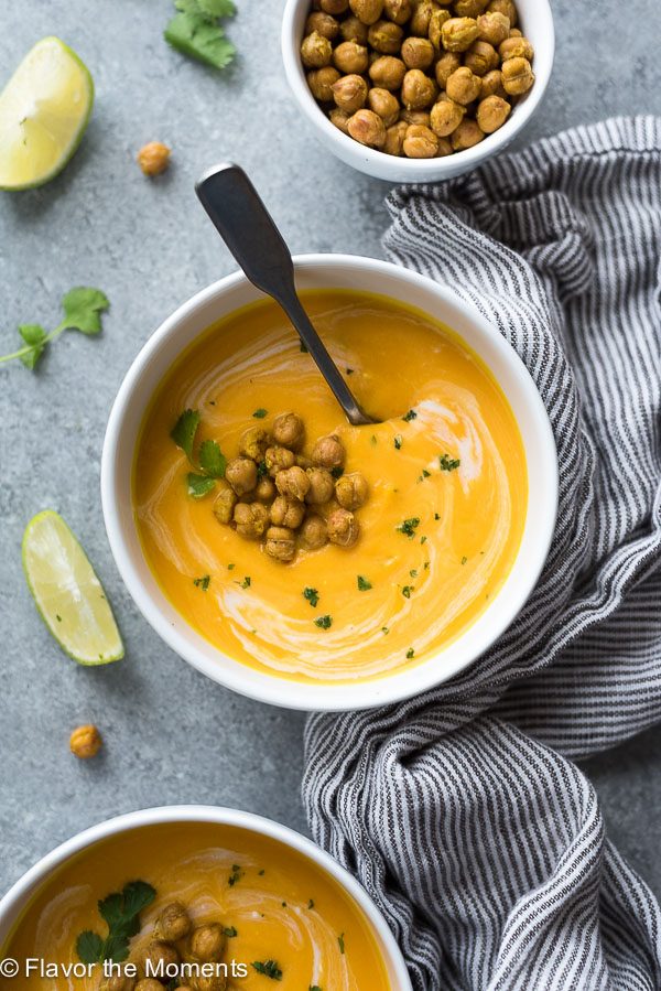 carrot ginger soup with crispy chickpeas overhead shot with spoon