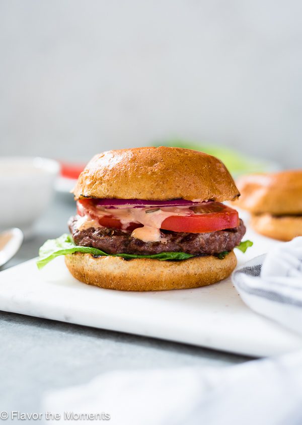 A juicy homemade burger on a white plate 