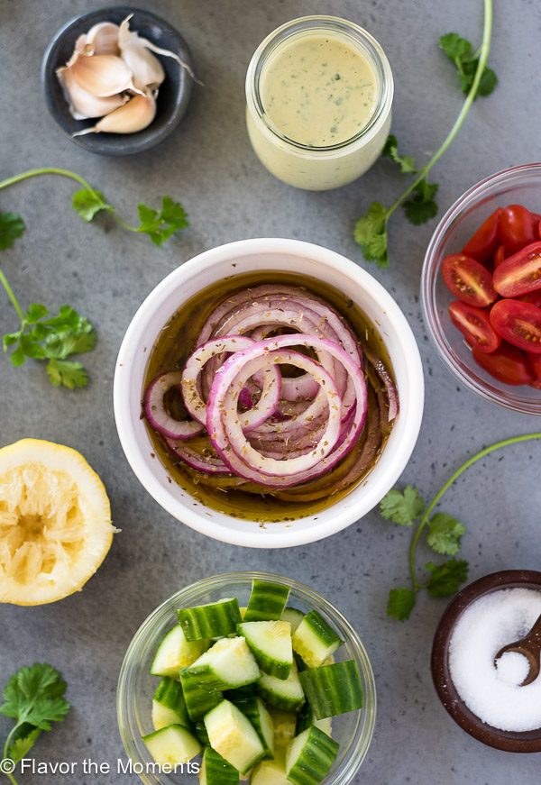 marinated red onions, garlic tahini dressing and other salad ingredients