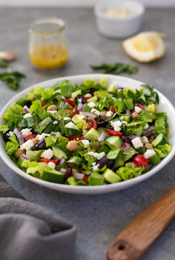 front view of Greek chopped salad in white bowl