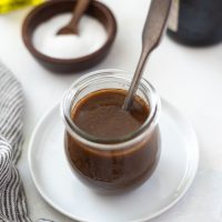 balsamic vinaigrette dressing in a jar with a spoon