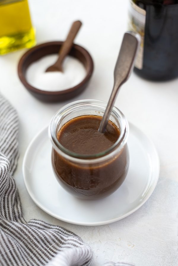 balsamic vinaigrette dressing in a jar with a spoon