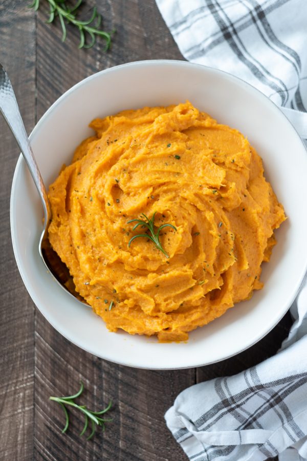 close up overhead shot of bowl of instant pot mashed sweet potatoes with rosemary