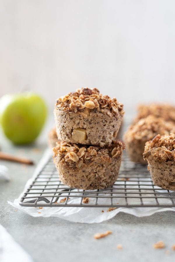 apple crisp baked oatmeal cups stacked up on a wire rack