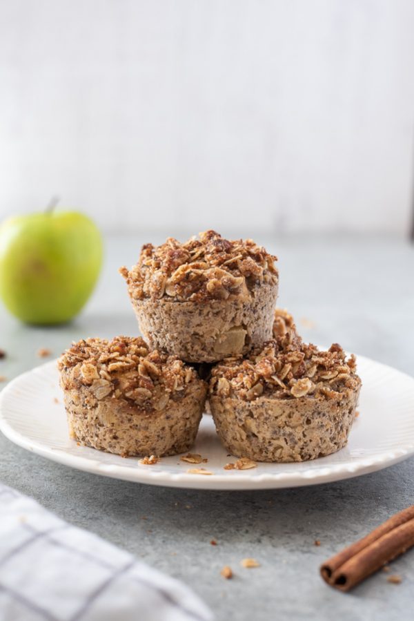 apple crisp baked oatmeal cups piled on a white plate
