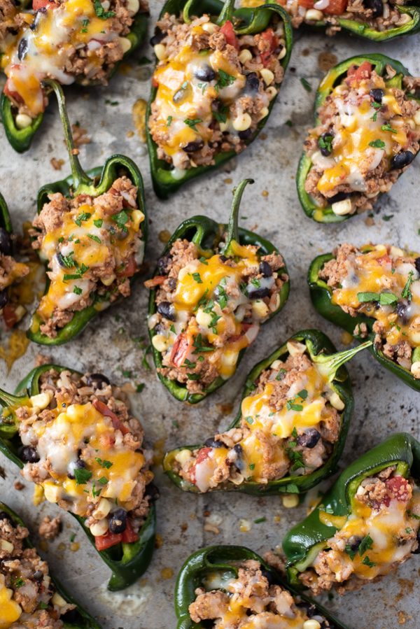 overhead shot of stuffed poblano peppers on a sheet pan