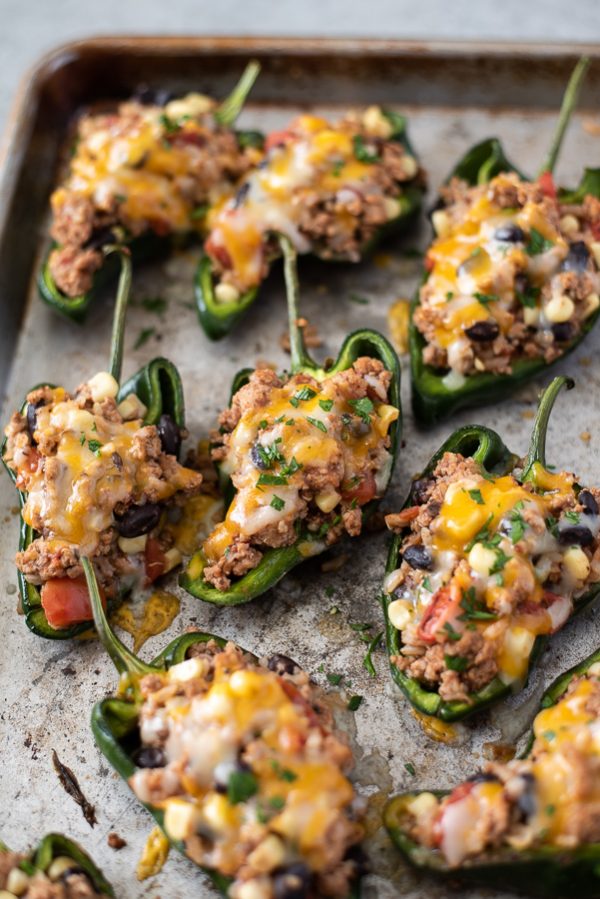 stuffed poblano peppers on a sheet pan