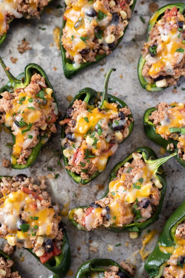 close up shot of stuffed poblano peppers with melted cheese on top