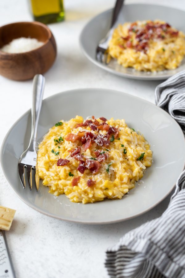 close up of pumpkin risotto instant pot topped with crumbled bacon