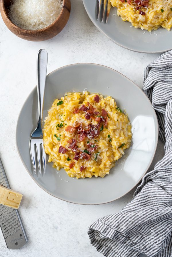 overhead shot of instant pot pumpkin risotto with crumbled bacon