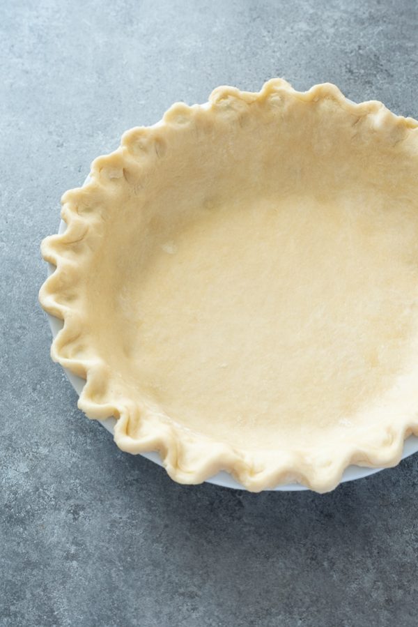 front view of flaky pie crust in pie plate