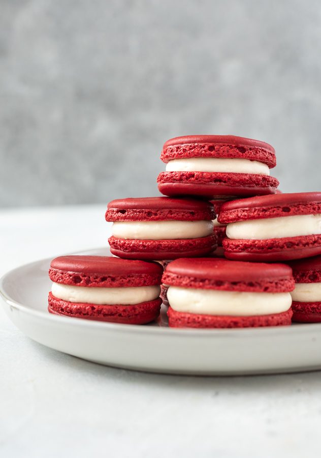 plate of red velvet macarons stacked up