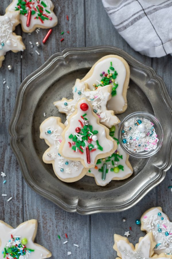 Christmas sugar cookies on plate with sprinkles